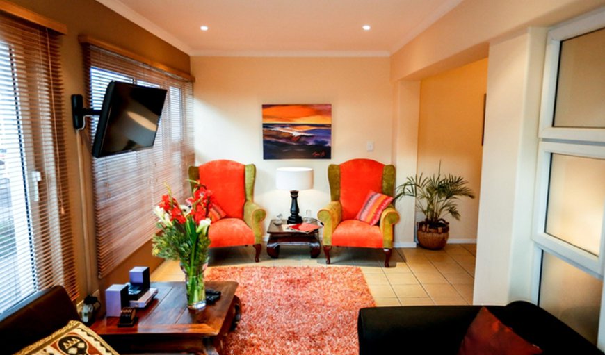 Luxury King Suite: This Luxury Suite embodies the Secret Garden Guesthouse theme of Afro-chic elegance with features such as a leather sleeper couch, a rich plush carpet and retro wingedback chairs.