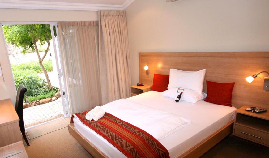 Deluxe Room: Deluxe Room - Each room has direct access to the garden and pool and is furnished with an extra length queen-size bed with an en-suite bathroom containing a shower.
