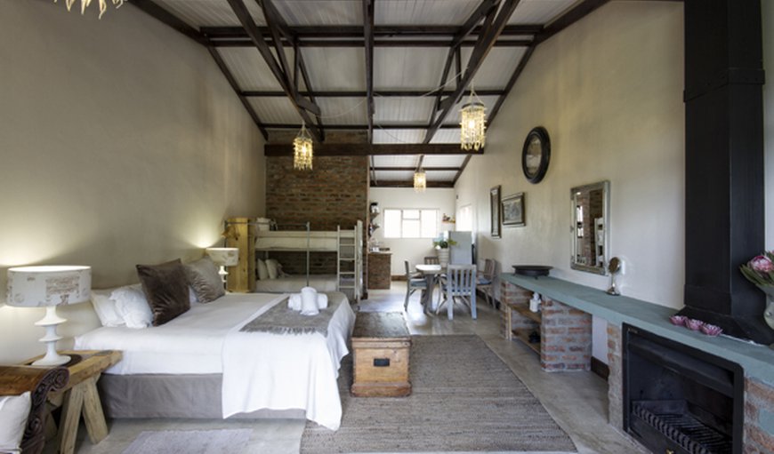 Deluxe family suite: open plan room with king bed & 2 bunk beds. en-suite bathroom,with a bath/shower in Swellendam, Western Cape, South Africa