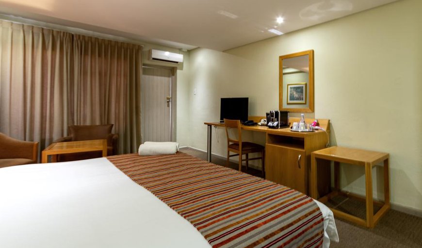 King Room: King Room - These spacious air conditioned rooms offer a king size bed, a flat screen TV, a comfortable seating area, a work desk, and coffee/tea making facilities.