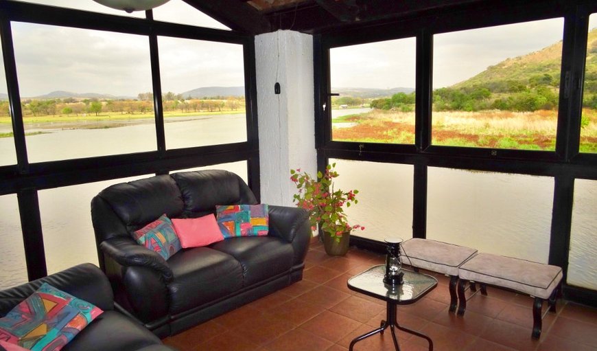 Modern Self-Catering House: Patio with views over the Crocodile River- glass windows can be fully opened.