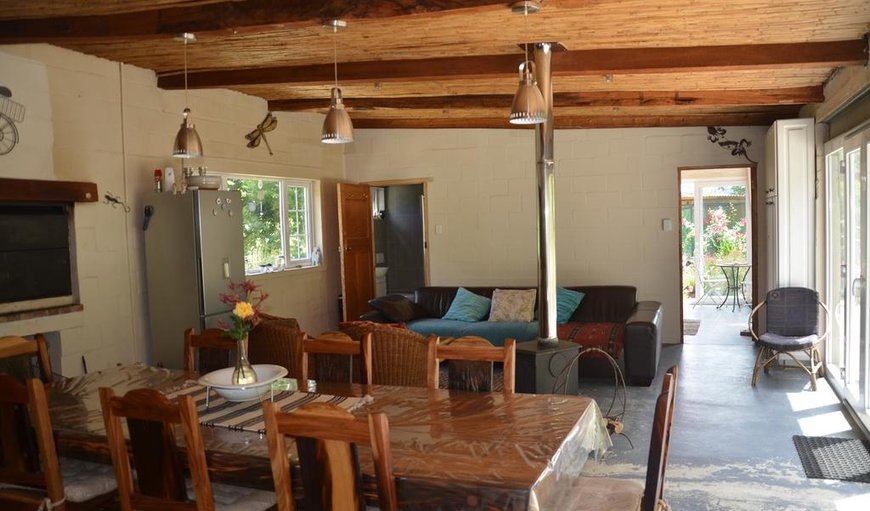 The cottage offers a large lounge/dining area with comfortable couches, a dining table and a braai area.