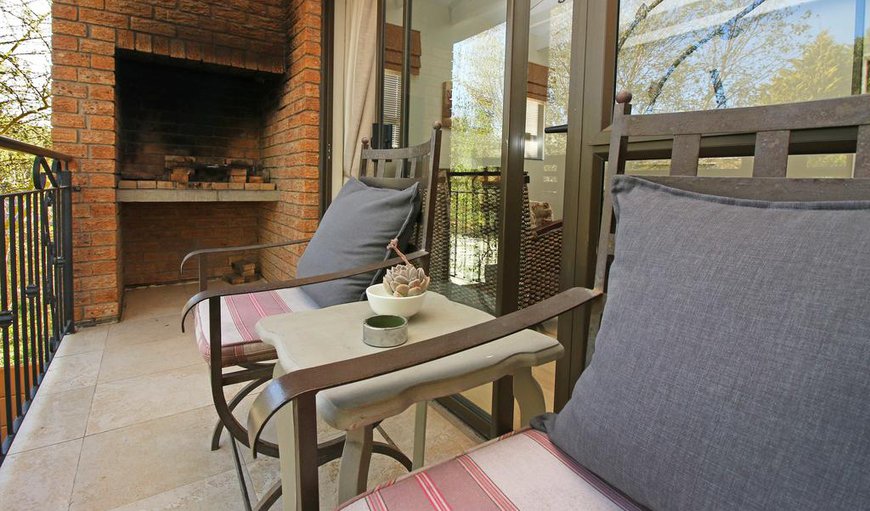 One bedroom apartment with balcony: One bedroom apartment with balcony - This apartment features a living room with sliding doors leading out onto a small balcony with a built-in braai.