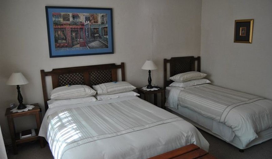 Room 2: Room 2 - This bedroom is comfortably furnished with a double bed and 2 single beds