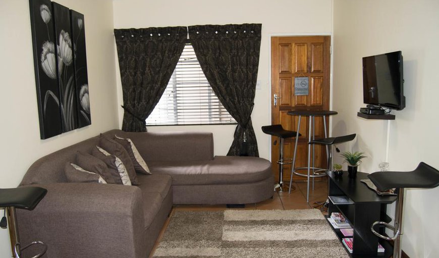 Comfort 2 Room: Jakkalsdraai 2-Bedroom Cottage - The lounge has a TV with selected DSTV channels.
