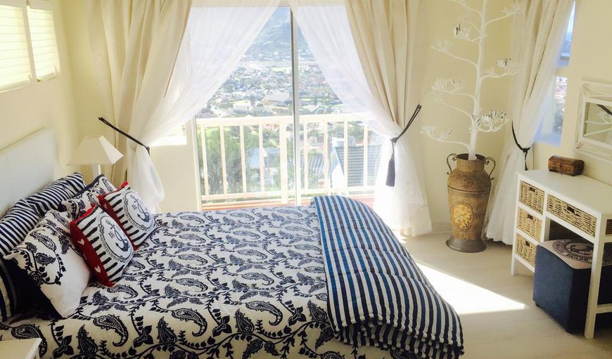 Coral Reef Suite main bedroom with queen size bed and mountain and sea views.