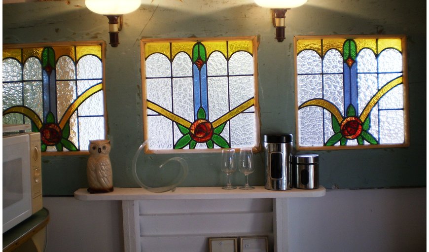 The old kitchen was made from salvaged and reclaimed material. These three beautiful stained glass windows were found in an old cellar and a window front was created with them