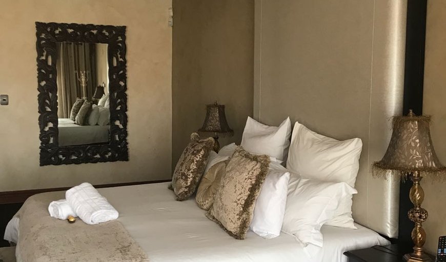 Presidential Suite: Presidential Suite - This spacious en-suite bedroom is furnished with a king size bed, a TV with DSTV, a bar fridge and a kettle with complimentary tea and coffee.