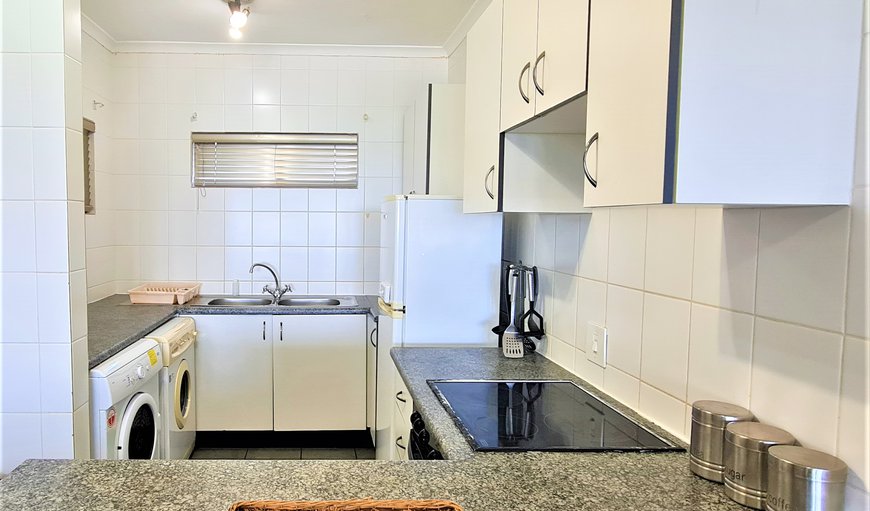 Kitchen with fridge/freezer, stove, oven, kettle, toaster, microwave and washing machine