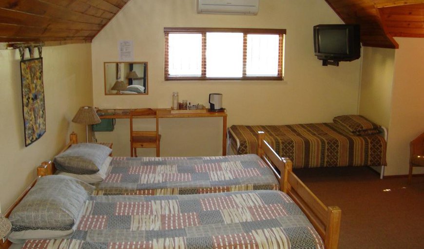 Family Room: Family Room - The family room is located upstairs consisting of three single beds and another adjoining doublebunk-bed room, as well as a colour remote TV with MNet, coffee/tea making facilities and an en-suite bathroom.