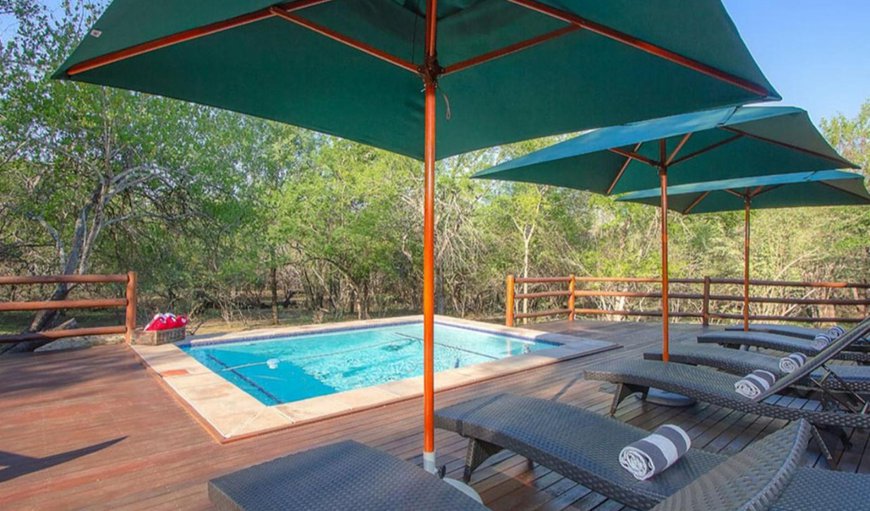 The lodge features a deck with an outdoor swimming pool